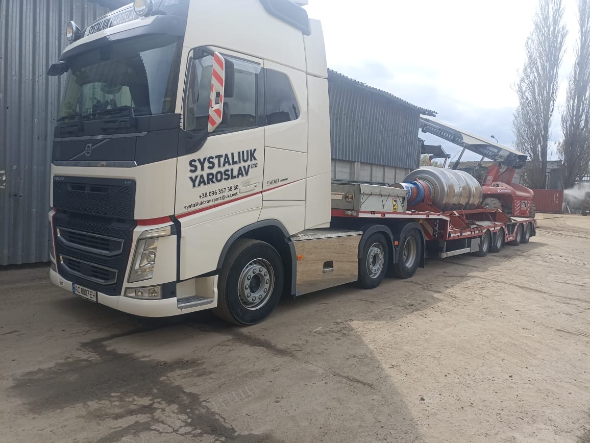 Heavy industrial rollers loaded on a Ukrainian heavy-haulage low-bed trailer